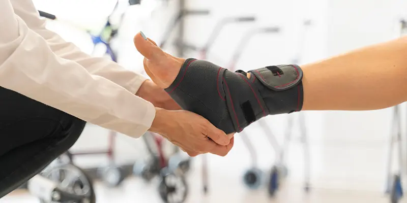 person helping fit an ankle brace